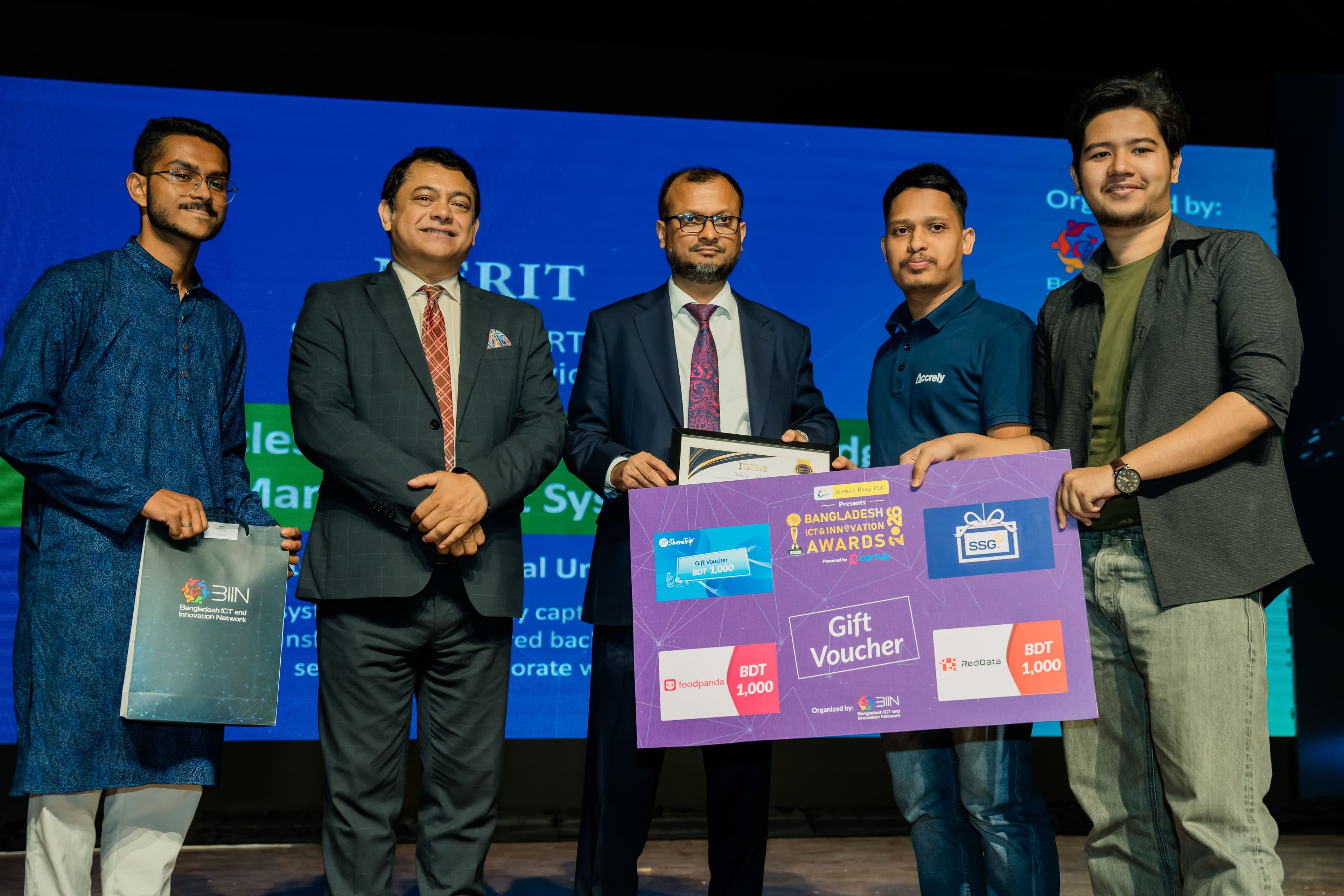 Accrely team on stage receiving the Business Category Merit Award at the BIIN 2026 ceremony